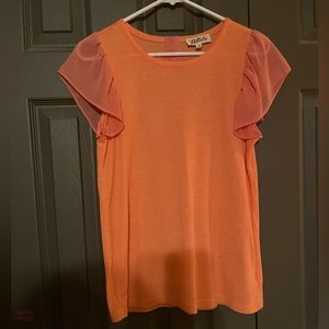 Orange top, buttons down the back